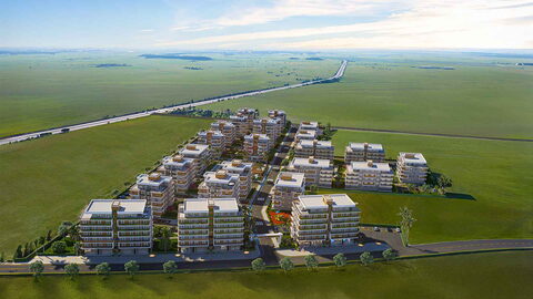 Olea Residence — Ova içinde havadan yerleşim: apartman blokları ve çevredeki geniş yeşil tarlalar görselleştirmesi