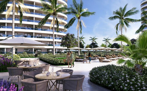 Ocean Life Residence — Havuz kenarında kafe masaları, çiçekli yürüyüş alanı ve arkada kuleler (görselleştirme)